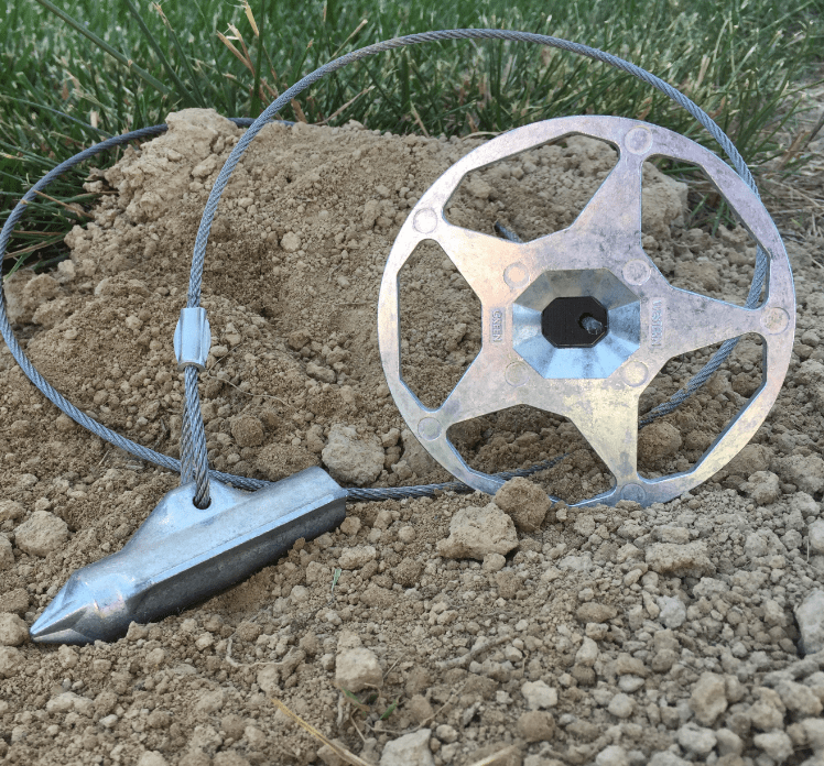 Falcon Anchors products resting on a dirt mound